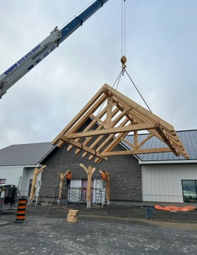 Heavy-duty construction crane lifting timber framework.