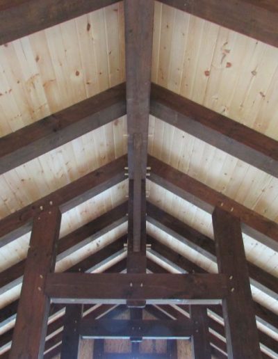 Durable, custom timber roof trusses designed for beauty and strength in rustic structures.